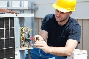 electrician working on air conditioning unit